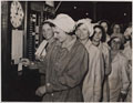Clocking in for work in a munitions factory, 1940