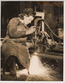 'Miss Betty Crawford cutting steel plates with an oxygen and gas cutter', 1941 (c)