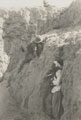 Staged scene of combat with a concealed North West Frontier tribesman waiting to ambush a British soldier in rocky terrain, 1937