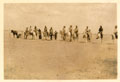 Egyptians and British soldiers taking part in a donkey race across the desert, Palestine, 1917