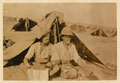 Corporal Joseph Egerton and a comrade reading a newspaper outside their tent, 1917 (c)