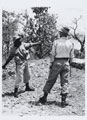 An askari throwing the 36 Mills grenade, 1956 (c)