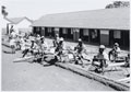 Soldiers of 4th (Uganda) Battalion, King's African Rifles waiting at Quartermaster's stores, 1956-1957 (c)