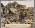 'A Canadian artilleryman carrying shells over bad ground in a recently captured village', 1918