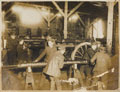 'In a gun-repair shop near the British front line; renewing the springs of a gun recoil', 1916