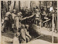'On the right of the new line taken over from the French. British and French troops make friends outside a dug-out', 16 March 1918