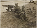 Machine gunners take up a position in a ditch in France, 1914 (c)