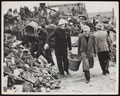 A clergyman and Civil Defence workers helping to clear the debris of a school, 1940