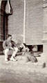 Man in civilian dress with two dogs, India, 1905-1920 (c)