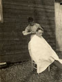 'Cutting Jimmy's hair', 25th (County of London) (Cyclists) Battalion, The London Regiment, Weybourne, 1915