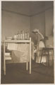 A nursing sister changing the dressing on 2nd Lieutenant Cyril Edwards' wounded leg at Endsleigh Palace Hospital, September 1917