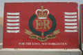 Concrete blast wall section decorated with a mural of Royal Military Police insignia, Basra, Iraq, 2009