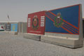 Concrete blast wall sections decorated with murals of Royal Military Police insignia, Basra, Iraq, 2009