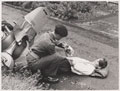A soldier of the Welsh Guards administers first aid as part of a simulated traffic accident, no date