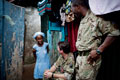 Sergeant Solomon Kamira and Brigadier Charlie Herbert meeting a survivor, 13 October 2015