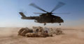 Members of a Queen's Royal Lancers patrol take cover from the dust in a Merlin helicopter's downdraught, Iraq, 2007