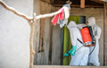 Two members of the decontamination team enter a contaminated property, Sierra Leone, Operation GRITROCK, 2015