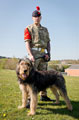 A lance corporal of the 1st Battalion Royal Regiment of Fusiliers with the unit's 'stand in' mascot, 'George' the Otterhound, 2015