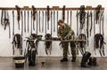 A gunner from King's Troop, Royal Horse Artillery cleaning tack while on Christmas Duty, Woolwich Barracks, 2015