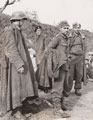 A soldier watches three German prisoners captured by 8th Army patrols, 1944