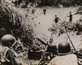 American infantry cross a jungle stream covered by a machine gun, New Guinea, 1943 (c)