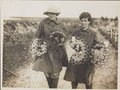 Two members of the Women's Army Auxiliary Corps carrying wreaths to lay on soldier's graves, 1917 (c)