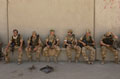 Soldiers of the Cheshire Regiment take a short break on patrol in Basra, June 2004