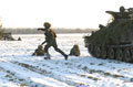 An assault section from The Light Dragoons disembarks from a Spartan armoured personnel carrier, Robertson Barracks, Norfolk, March 2004