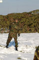 A member of The Light Dragoons hurls a snowball, Robertson Barracks, Norfolk, March 2004