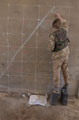 A second-lieutenant serving with 1st Battalion Irish Guards, prepares a large scale map for an orders group, Iraq, 2003.