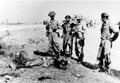 Indian Army troops inspect a dead Japanese soldier, Burma, 1945