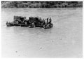 Askaris and trucks fording a flooded area during the monsoon, Burma, 1944