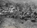 Indian troops moving ammunition down a slope, Tamu Road, Burma, 1944 (c)
