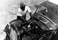 A driver of the 10th Belgian Congo Casualty Clearing Station (CCS) checks the engine of his ambulance, Burma, 1944