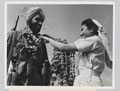 A Sikh soldier receives a garland of flowers from a nurse, 1946 (c)