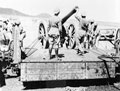 Soldiers of the Royal Artillery pulling a 5-inch gun on to a railway truck, 1900 (c)