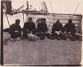 Men of the West Riding Regiment loading Maxim machine gun belts, en route to South Africa, 1900