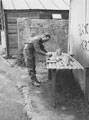A member of 3rd County of London Yeomanry (Sharpshooters) blancoing his kit, Westbury, 1941