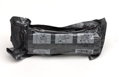 Emergency bandage in dark grey plastic wrapper, 2009