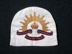 Embroidered textile, probably a tea cosy, commemorating the British Red Cross Society and Australian forces, 1918 (c)