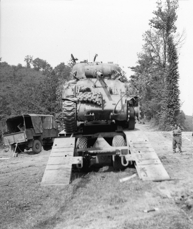 Sherman tank of  3rd/4th County of London Yeomanry driven on to a transporter, 1944