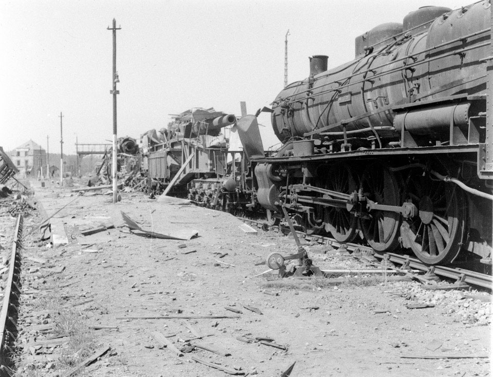 Destroyed railway engine and German guns, Vire, Normandy, 1944