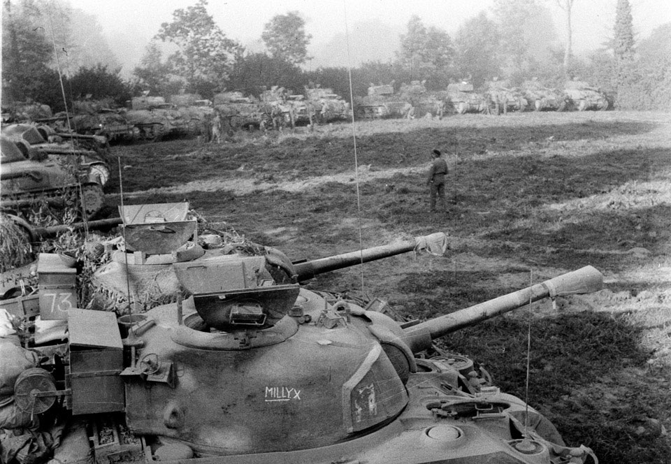Sherman tanks refuelling while waiting to go on transporters, Normandy, 1944