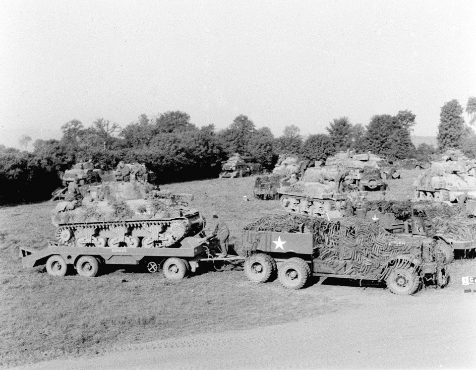 Loading Sherman tanks on Diamond T transporters, 1944