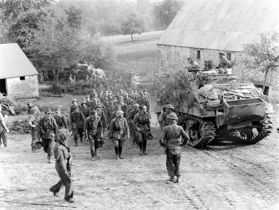 German POWs marching past a Sherman tank, Normandy, 1944
