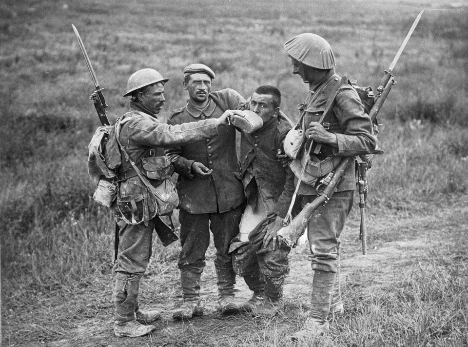 British soldiers offering water to German prisoners of war, 1917 (c)