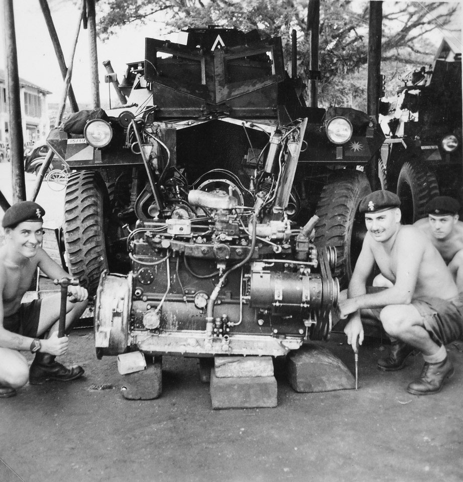 REME craftsmen repairing the engine of a 15th/19th King's Royal Hussars Saracen Armoured Personnel Carrier, 1957