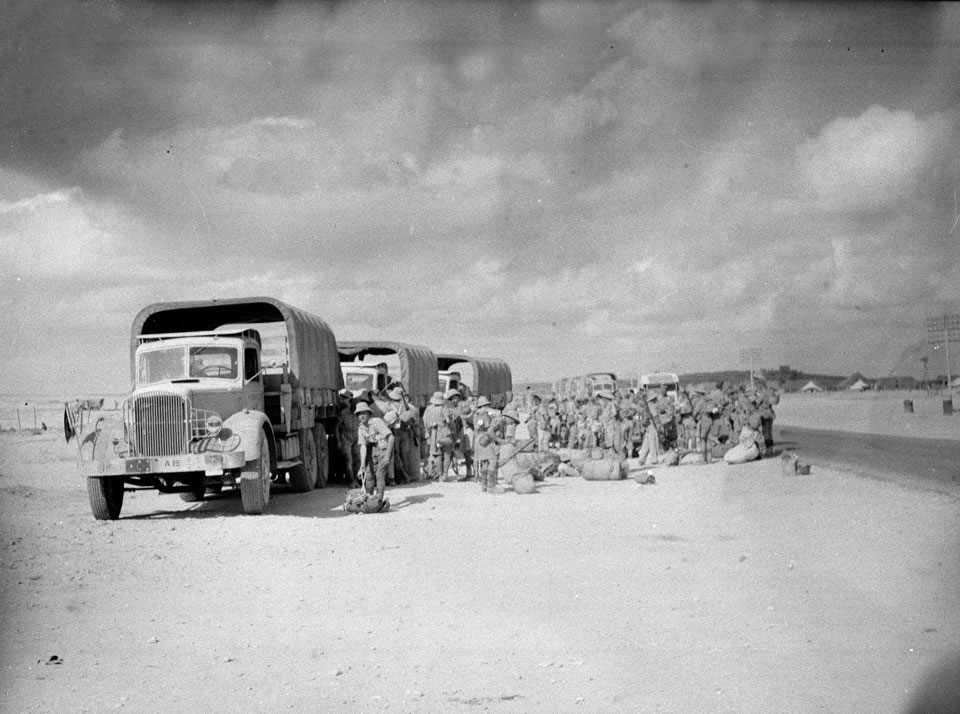 Troops in tropical dress next to a convoy of trucks, Amiriya, Egypt, 1941