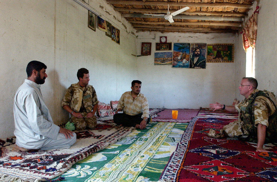 British soldiers talk to an Iraqi farmer, in Al Amarah, Iraq, July 2004