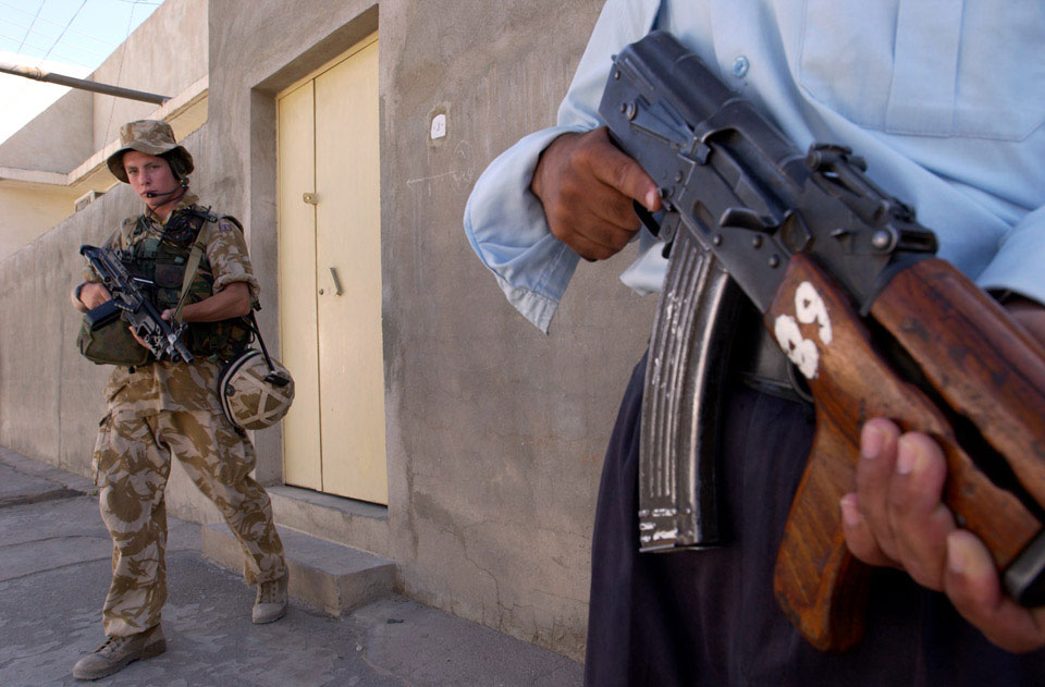 A private from the Cheshire Regiment and an Iraqi policeman, Basra, June 2004